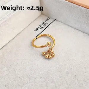 Gold plated open ring with dangling beads and a ball pendant in a velvet box