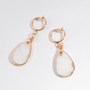 Detail of drop earrings with white shell pendants and gold wire-wrapped metal edges