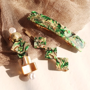 Three-piece hair clip set with green shell pattern, pearls, and golden metal finish