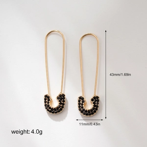 Detailed view of gold safety pin earrings with black zircons, showing 43mm height dimensions