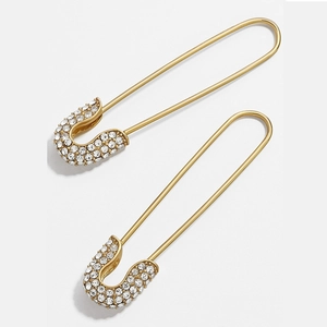 Detail view of gold safety pin earrings featuring sparkling micro-pave cubic zirconia