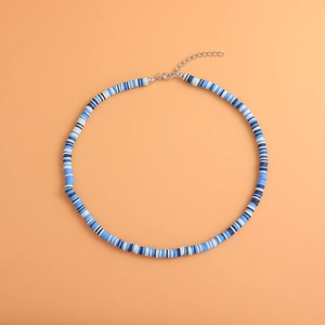 Detail of blue and white Heishi clay bead necklace with silver lobster clasp and chain