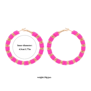 Macro detail of 45mm Bohemian colorful clay hoop earrings with golden metal spacer beads