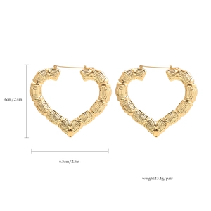 Detail view of 14K gold-plated heart hoop earrings with bamboo texture and size metrics