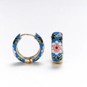 Detail of vintage flower enamel hoop earrings with blue glaze and pink floral motifs