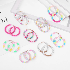 Detail of colorful heishi clay bead hoop earrings in various vibrant candy color palettes