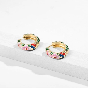 Detailed close-up of retro enamel floral hoop earrings with colorful hand-painted flowers