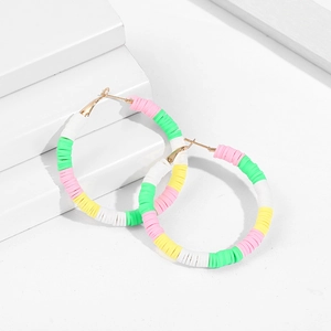 Macro detail of multi-color heishi beads on bohemian C-shape hoop earrings for beach style