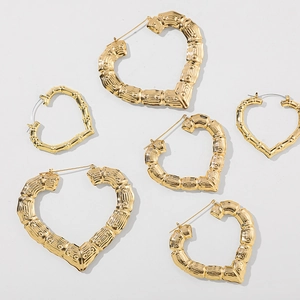 Detailed view of three pairs of 14K gold plated heart earrings with bamboo texture