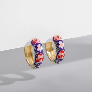 Detailed macro shot of vintage floral enamel hoop earrings with vibrant colorful patterns