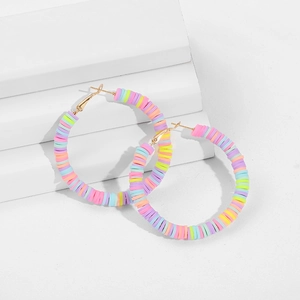 Macro detail of Bohemian C-shape hoop earrings with colorful polymer clay heishi beads