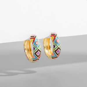 Detail of gold hoop earrings with colorful geometric enamel patterns in vintage style