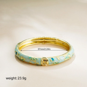 Detail of vintage enamel bangle with blue floral patterns and 57mm inner diameter