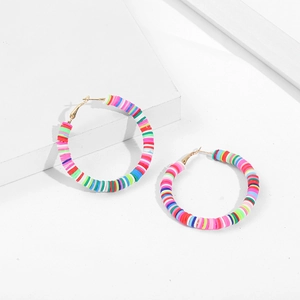 Detailed close-up of colorful rainbow polymer clay disc hoop earrings with golden hooks