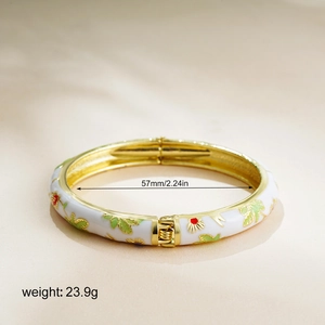 Detail of 14K gold enamel bracelet showing spring hinge and colorful floral patterns