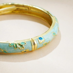 14K gold plated bangle with mint blue enamel flower motifs and polished hinge details