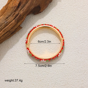 Detailed size view of red enamel flower bangle with 14K gold plating and spring closure