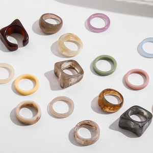 Y2K colorful resin rings set with tortoise shell and marble patterns on white background