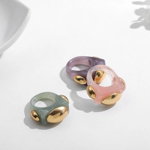 Three-piece chunky resin rings set with marble texture and golden oval metal details