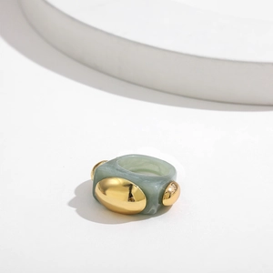 Detail of light green marble resin ring featuring gold metallic oval accents