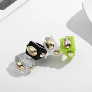 Chunky Y2K resin square rings set in candy colors with three gold bead accents