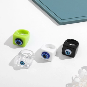Set of four resin square rings with Evil Eye motif in green, black, white, and clear