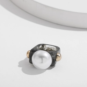 Detail of square resin ring with marble texture, large faux pearl and gold beads