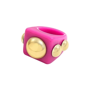Detail of pink resin Y2K ring with gold studded accents and high-gloss finish