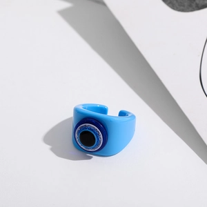 Detailed view of the blue resin evil eye open ring featuring layered Mediterranean style