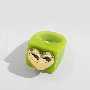 Y2K style bright green square resin ring featuring a large metallic gold heart detail
