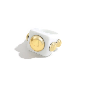 Y2K resin statement ring with gold metallic geometric domes on a white square band
