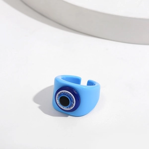 Macro view of blue evil eye resin ring featuring an adjustable open band design
