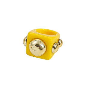 Chunky yellow resin Y2K ring with polished gold sphere studs and a square geometric design