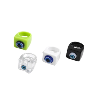 Set of four colorful resin evil eye rings in green, transparent, white and black