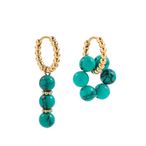 Asymmetric Y2K earrings with gold beads and turquoise floral clusters on white background