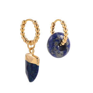 Detailed shot of asymmetric gold hoops with deep blue lapis lazuli stone pendants