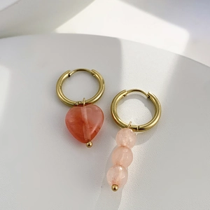 Détails des boucles d'oreilles asymétriques avec pierre rouge et perles roses