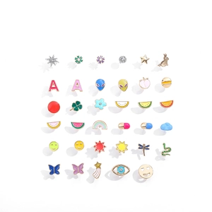 Macro view of assorted Y2K colorful enamel stud earrings set featuring cartoon icons
