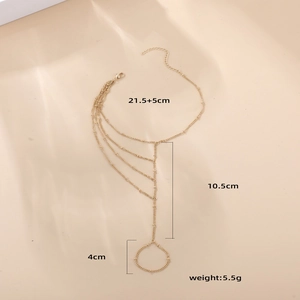 Detail eines mehrlagigen 18K Gold Fingerarmbands mit Maßangaben und Gewicht