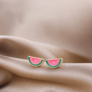 Macro shot of watermelon stud earrings with pink enamel and green rind details