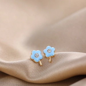 Close-up of a blue enamel five-petal flower stud earring with a central clear zircon