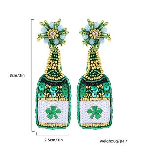 Detailed beaded St. Patrick's Day earrings in champagne bottle shape with green clovers