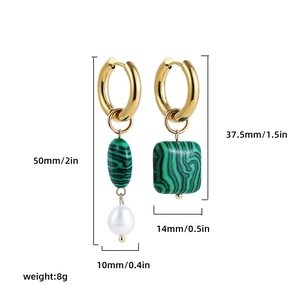 Macro detail of asymmetric geometric earrings with natural green stone and white pearl