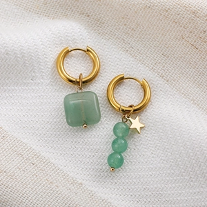 Asymmetric gold hoop earrings with green natural stones and a small star pendant charm