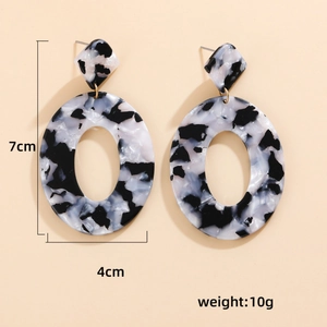 Orecchini a cerchio in acrilico con trama marmo bianco e nero in stile geometrico ovale