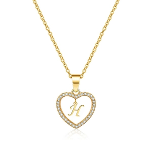 Detail of gold heart pendant with micro-pave cubic zirconia and hollow letter H on chain