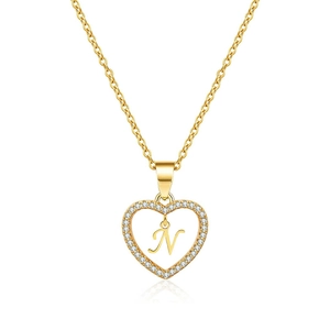 Close-up of gold heart pendant necklace featuring micro-set zircon and cursive letter N