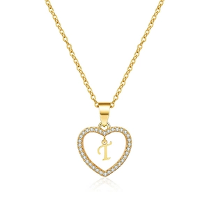 Macro shot of gold hollow heart pendant with micro-paved zircons and letter T