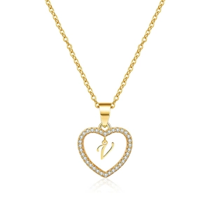 Detail of gold heart pendant necklace featuring zircon pavé and scripted letter V