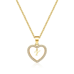 Close-up of golden heart pendant with letter Y and micro-set cubic zirconia stones